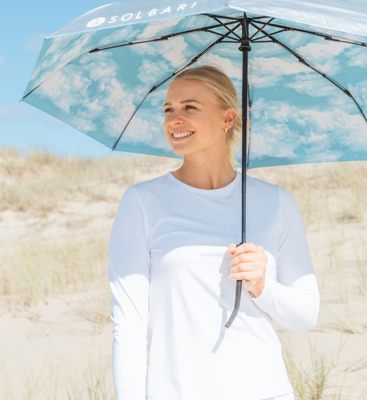 Women in Solbari UPF 50+ top and sun umbrella