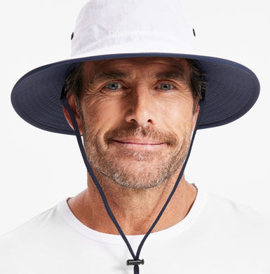Man wearing a white hat with a navy neck cord.