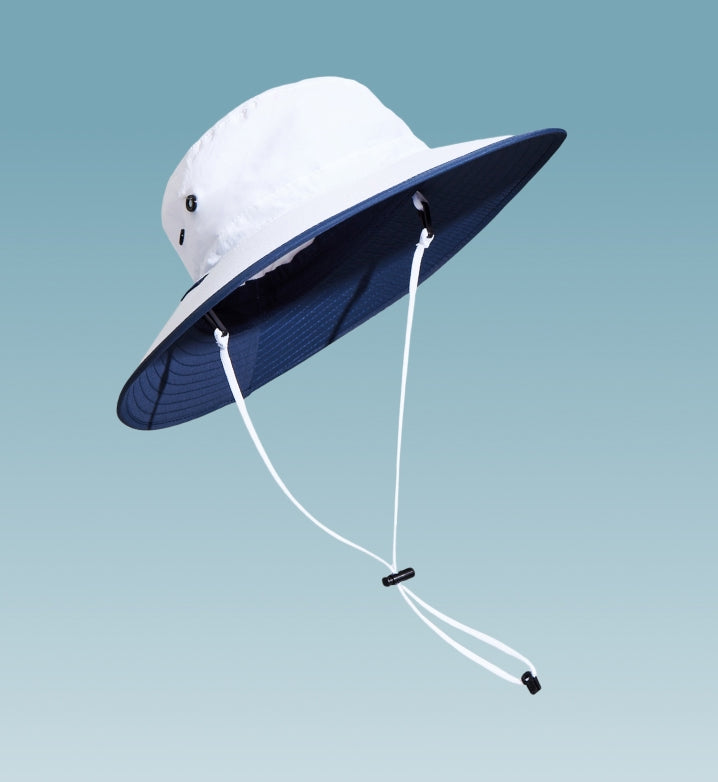 A white sun hat floating on a light blue background.