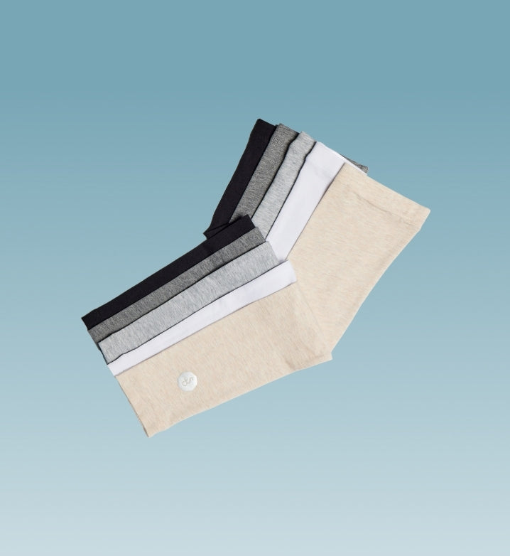 Solbari arm sleeves floating on a light blue background.