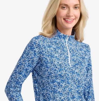 Woman wearing a blue and white patterned long-sleeve shirt on a white background