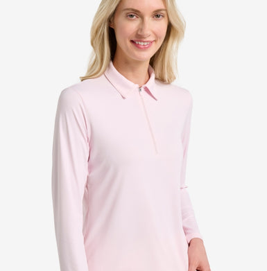 Woman wearing a light pink long-sleeve shirt on a white background.
