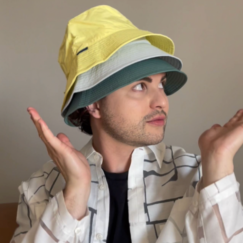 A man with three Solbari hats on his head